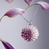 a delicate silver necklace suspending a tiny pink diamond dahlia