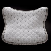 a quilted white saddle pad with diamond studs